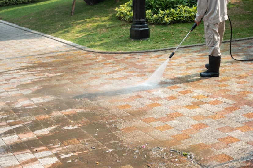 Cleaner pressure washing a driveway