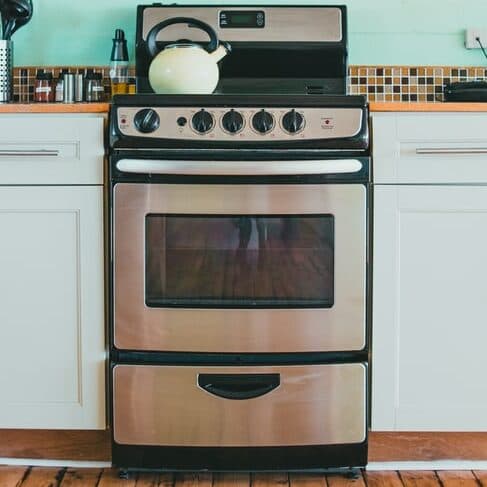 Stainless stove with tea kettle on top