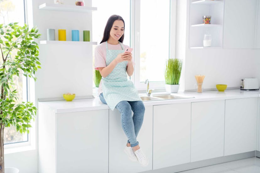 Cleaning on the phone using social media to promote her cleaning business