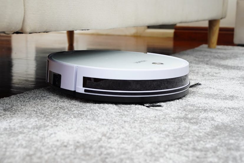 Robot vacuum going under the couch from a plush rug